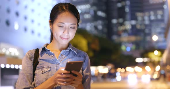 Woman use of smart phone at night 