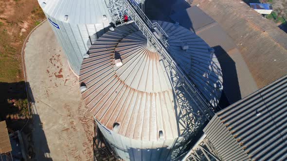 Aerial view of metal grain elevator in agricultural zone. Grain warehouse