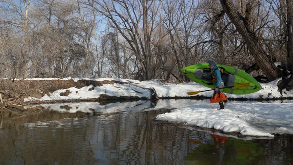 senior male paddler is launching inflatable kayak