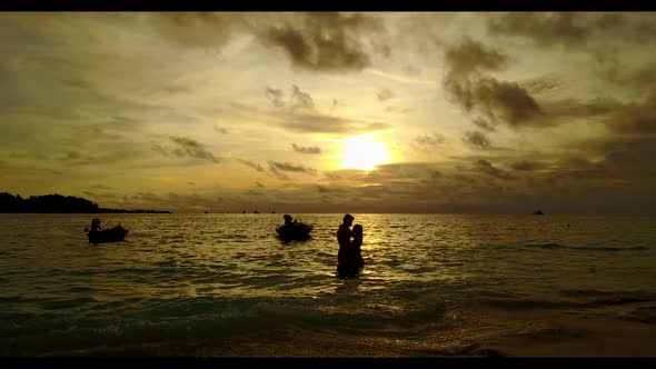 Guy and girl suntan on luxury island beach trip by blue water with white sandy background of the Mal