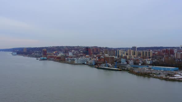 Aerial forward view of Yonkers city from Hudson river. USA