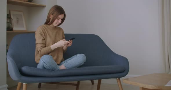 Business Woman Typing Message on Mobile Phone at Home Office. Young Girl Chatting on Phone in Slow