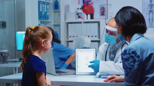 Medical Specialist Presenting Skeleton Using Tablet