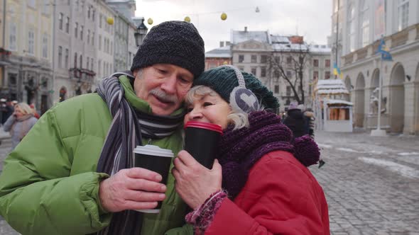 Senior Wife Husband Tourists Drinking From Cups Enjoying Hot Drink Tea on City Central Street