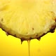 Freshly squeezed pineapple juice flows from the ripe fruit slice close - VideoHive Item for Sale