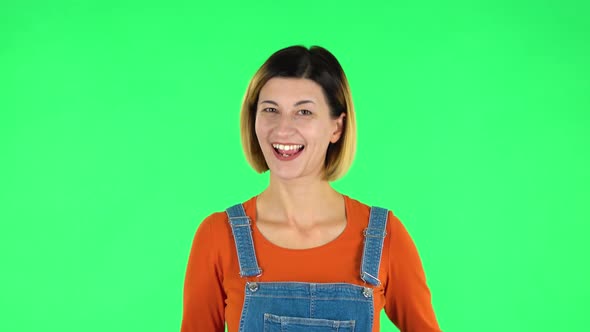 Cute Girl Smiles and Showing Heart with Fingers Then Blowing Kiss. Green Screen