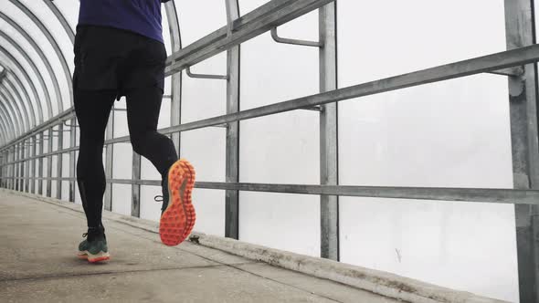 Running Man In Sportswear Workout Before Triathlon Sprinting In Glass Tunnel