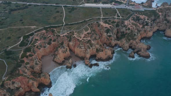 Establishing Aerial Drone View of Scenic Outdoor Coastline in Lagos Portugal Circling Pan Above