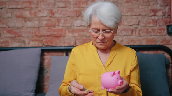 Satisfied Elderly Pensioner Saving Money in His Piggy Bank  Retirement Concept