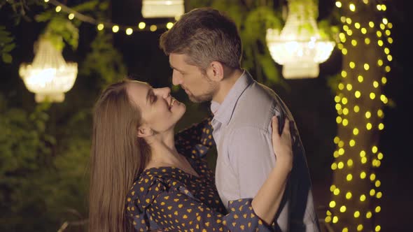 Smiling Romantic Man and Woman Dating at Summer Night Outdoors. Close-up Portrait