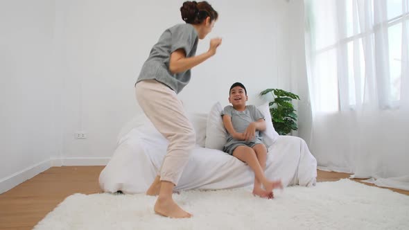 Happy family with mother and disabled son spending time together at home.