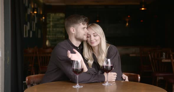 Young Boyfriend and Girlfriend Having Romantic Date in a Restaurant