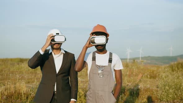 Indian Businessman in Suit and African American Engineer in Uniform Using VR