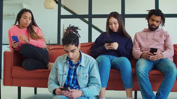 Multicultural Smartphone Addicted Friends Indoors
