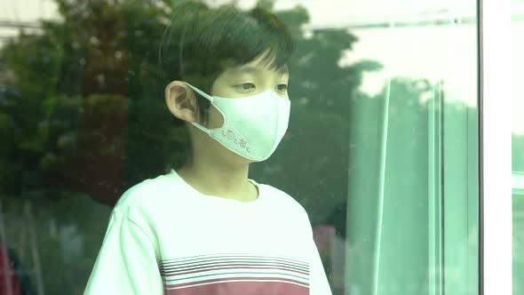 Asian Mother Puts A Safety Mask On Her Son's Face.Back To School Concept