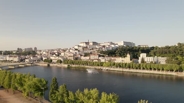 Aerial forward ascendent over Mondego river at Coimbra, Portugal