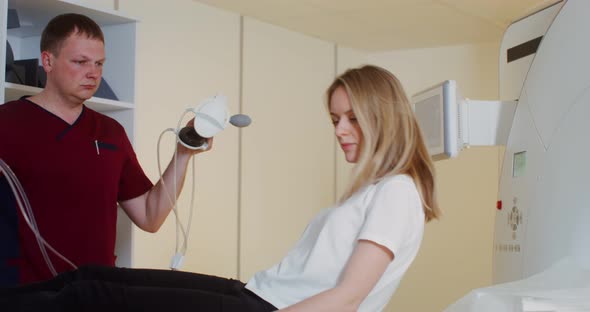 The Doctor Preparing Young Patient for an MRI Scan in a Modern Clinic