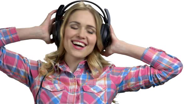 Woman with Headphones Enjoying Listening to Music