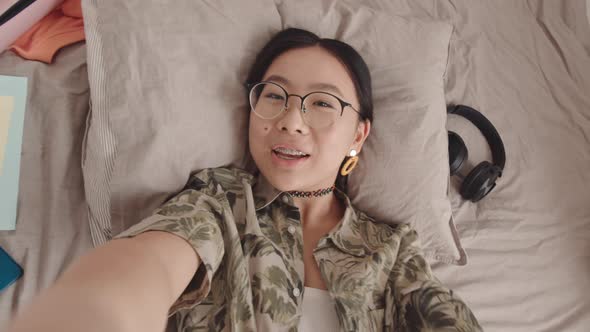 POV of Asian Gen Z Girl Recording Video Blog from Bed