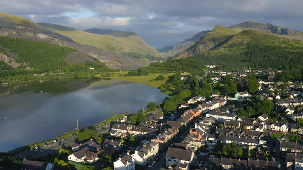 European Village near Mountain Lake Snowdonia in Wales - Aerial Drone Landscape