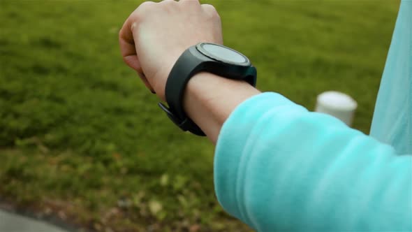 Woman Runner Using Smart Watch Fitness Tracker