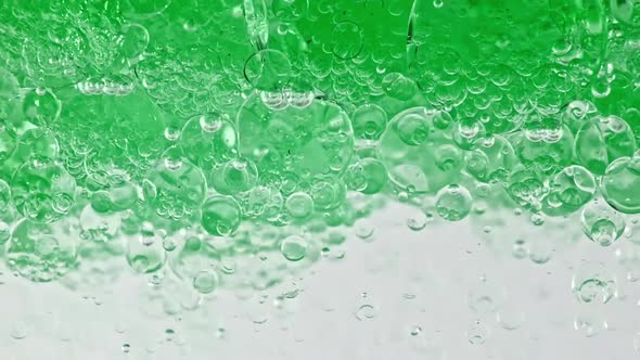 Macro Shot of Various Air Bubbles in Water Rising Up on Light White Background