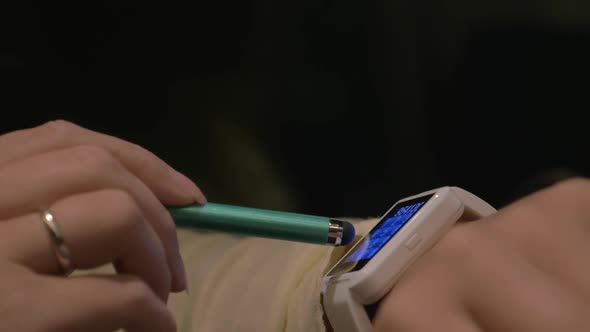 Woman Dialing Phone Number on Smart Watch