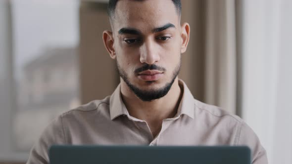 Serious Male Young Hispanic Business Man Investor Freelancer Agent Typing on Computer at Home Office