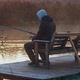 Man Holding Fishing Rod Sitting on the Riverside - VideoHive Item for Sale