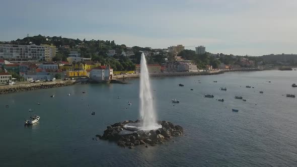 Aerial view around a Water Fountain from ocean, on the coast of Lisbon, Portugal