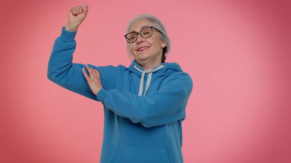 Senior Old Granny Woman Showing Biceps Looking Confident Feeling Power Strength to Fight for Rights