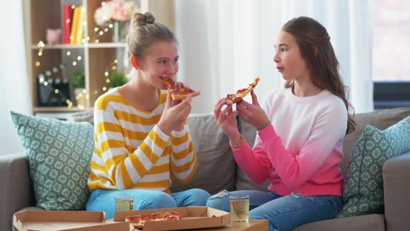 Happy Teenage Girls Eating Takeaway Pizza at Home