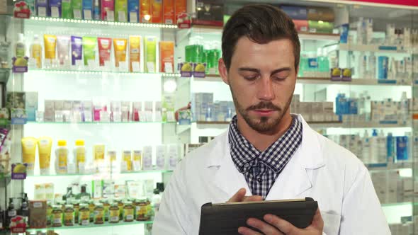 Druggist Examine Drugs Inventory with Digital Tablet