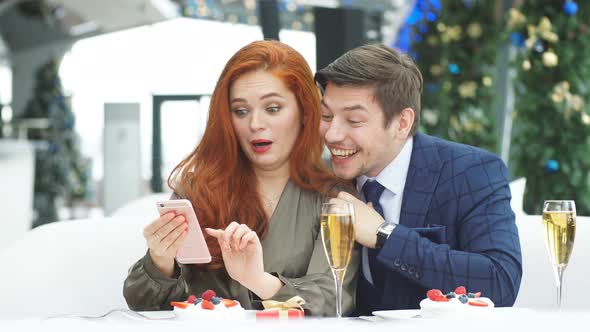 Happy Couple in Love Experience Violent Emotions Watching the News Feed on Smartphone.