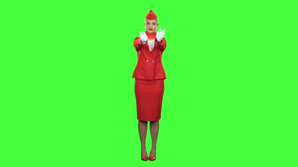 Stewardess Gestures Where the Emergency Exit Is. Green Screen