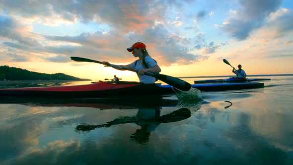 Slow Motion of People Paddling Across the Water