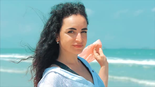 Portrait Caucasian Wonderful Brown-Haired Woman at the Beach. Soft Focus