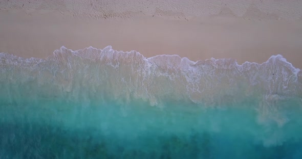 Tropical aerial travel shot of a white sandy paradise beach and aqua turquoise water background in c