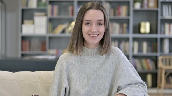 Portrait of Smiling Young Woman Looking at the Camera