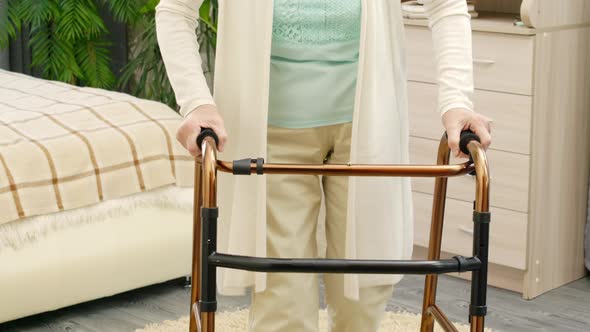 Elderly Woman Going with Walker at Home