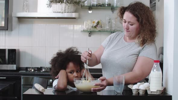 Mixed Family Baking  Black Little Girl and Her White Mother Making Liquid Dough in the Bowl