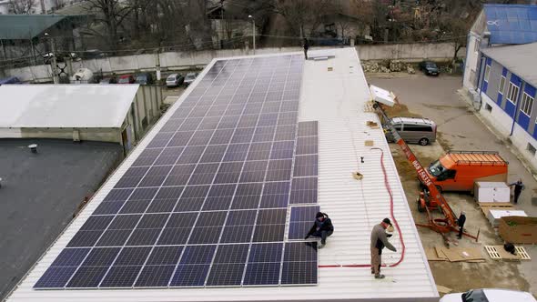 Solar Technician Installing Solar Panels on House Roof