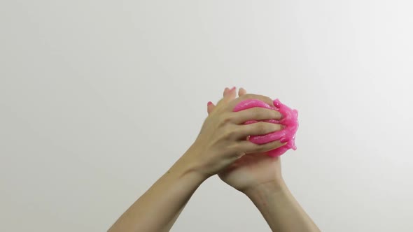 Woman Hands Playing Oddly Satisfying Pink Slime on White Backgroun,  Antistress