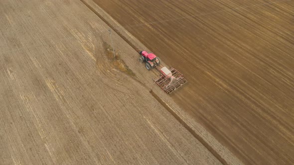 Tractor Passes Under Power Line