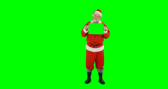 Santa claus holding blank board