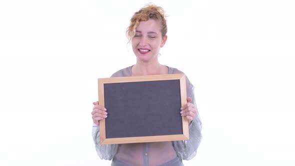 Happy Beautiful Blonde Woman Talking While Holding Blackboard