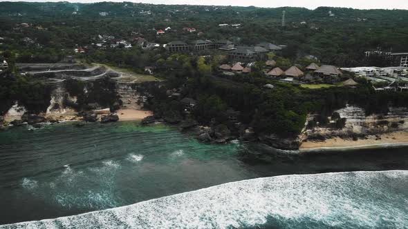 Beautiful Bingin beach with exotic cliffs houses and hotel located in Bali, Indonesia. This drone fo