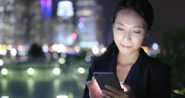 Businesswoman use of cellphone in Hong Kong city 