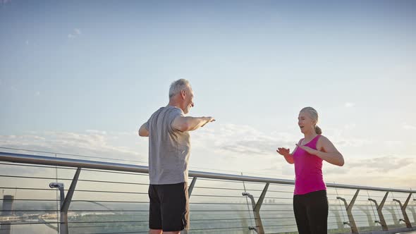 Sportive Aged Friends Do Exercise Warming Up Before Running