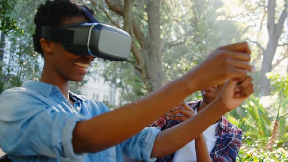 Twin sisters experiencing VR headset in the park 4k